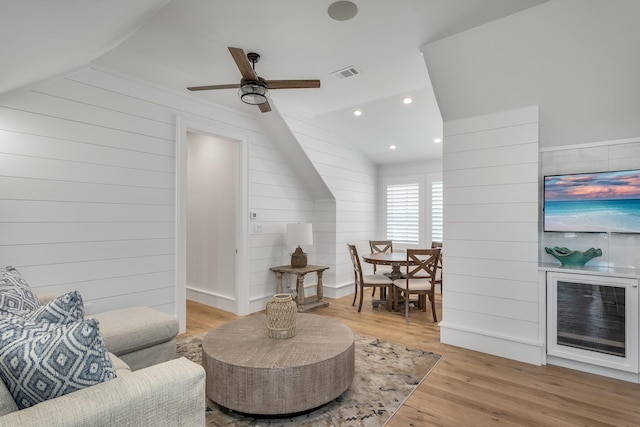 living room featuring visible vents, lofted ceiling, recessed lighting, wood finished floors, and a ceiling fan