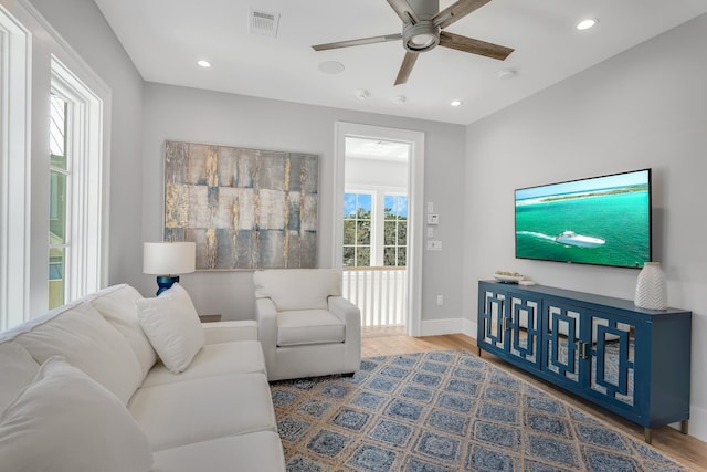 living area with visible vents, ceiling fan, baseboards, recessed lighting, and wood finished floors