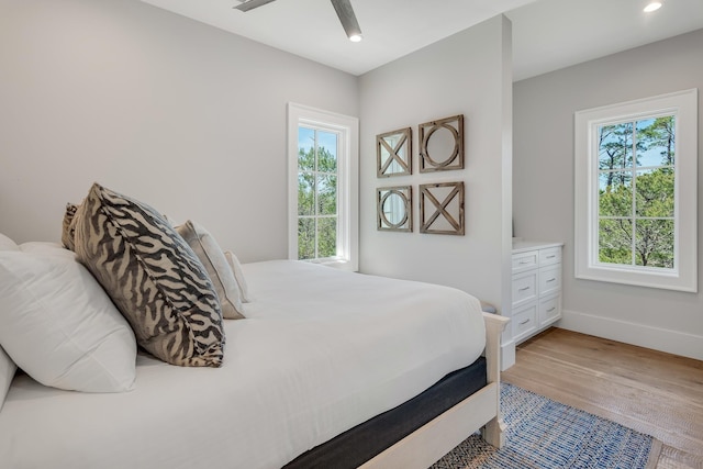 bedroom featuring recessed lighting, baseboards, wood finished floors, and a ceiling fan