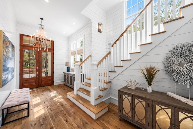 11 Dandelion Dr, Santa Rosa Beach, FL 32459 - entryway featuring stairs, hardwood / wood-style flooring, french doors, a chandelier, and wooden walls