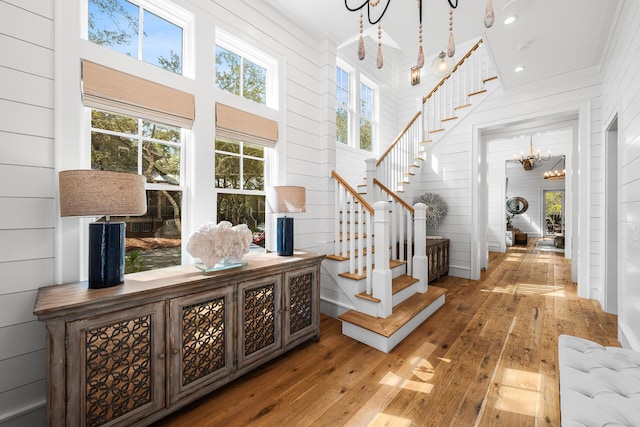 11 Dandelion Dr, Santa Rosa Beach, FL 32459 - foyer with a chandelier, stairs, hardwood / wood-style floors, wooden walls, and recessed lighting