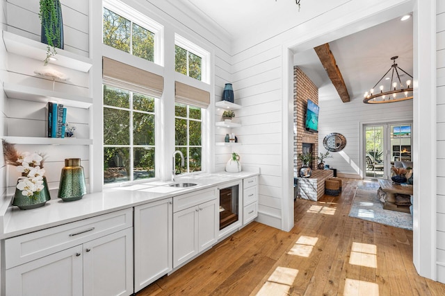 11 Dandelion Dr, Santa Rosa Beach, FL 32459 - bar featuring wine cooler, light wood-style floors, healthy amount of natural light, a chandelier, and beam ceiling