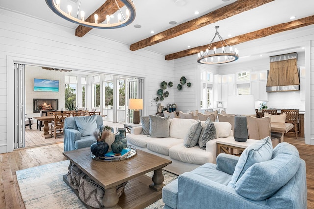 11 Dandelion Dr, Santa Rosa Beach, FL 32459 - living area with a chandelier, light wood finished floors, plenty of natural light, wood walls, and beamed ceiling