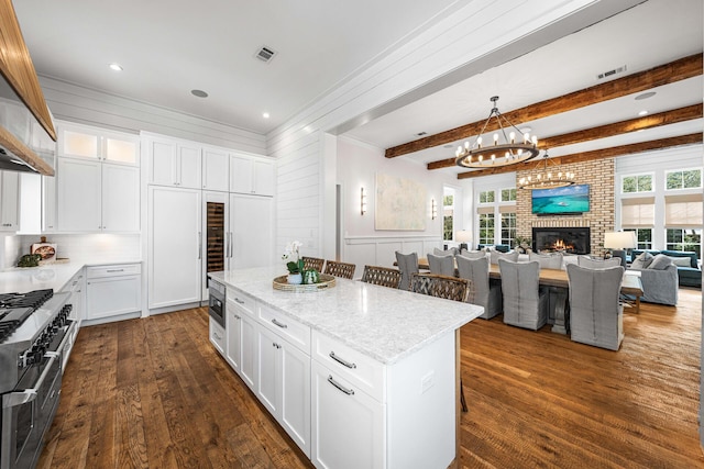 11 Dandelion Dr, Santa Rosa Beach, FL 32459 - kitchen featuring range with two ovens, open floor plan, a kitchen island, dark wood-style flooring, and a chandelier