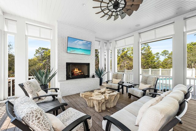 11 Dandelion Dr, Santa Rosa Beach, FL 32459 - sunroom / solarium with an outdoor living space with a fireplace, a ceiling fan, wood ceiling, healthy amount of natural light, and wood-type flooring