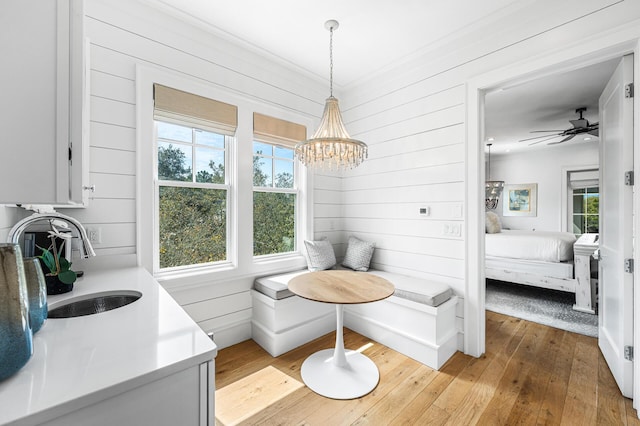 11 Dandelion Dr, Santa Rosa Beach, FL 32459 - dining room with hardwood / wood-style floors, a chandelier, and wooden walls