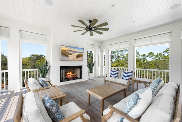 11 Dandelion Dr, Santa Rosa Beach, FL 32459 - sunroom featuring an outdoor living space with a fireplace, healthy amount of natural light, and ceiling fan