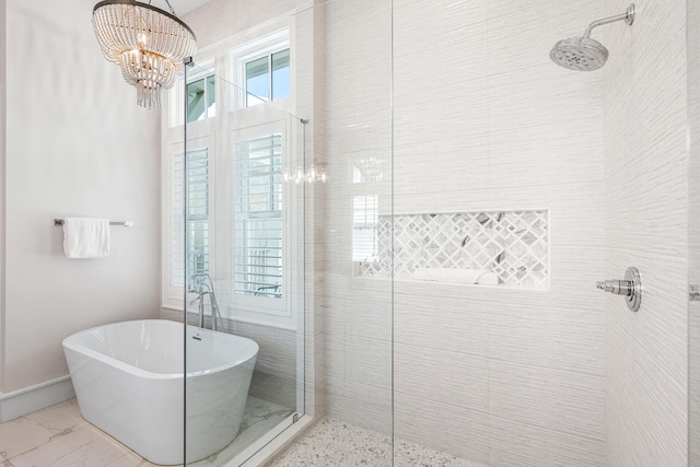 11 Dandelion Dr, Santa Rosa Beach, FL 32459 - bathroom featuring tiled shower, a freestanding bath, marble look tiles, and a chandelier