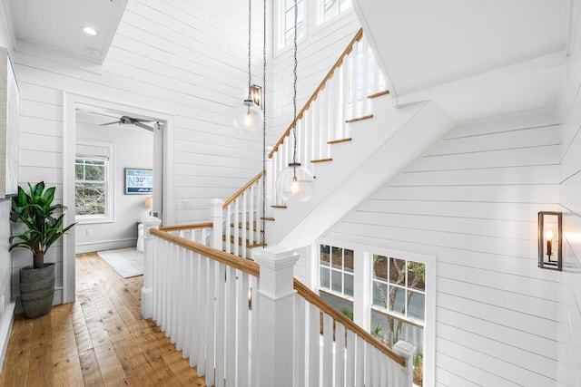 11 Dandelion Dr, Santa Rosa Beach, FL 32459 - staircase with wood walls, wood-type flooring, a towering ceiling, recessed lighting, and a ceiling fan