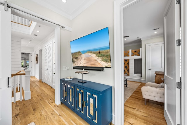 11 Dandelion Dr, Santa Rosa Beach, FL 32459 - hall with ornamental molding, wood-type flooring, an upstairs landing, a barn door, and recessed lighting