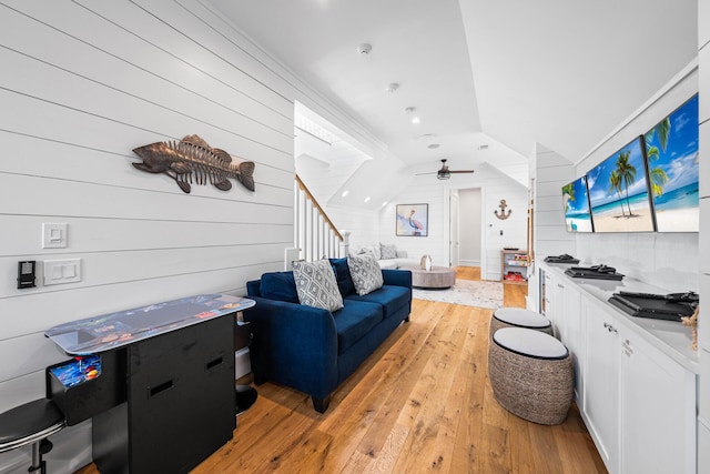 11 Dandelion Dr, Santa Rosa Beach, FL 32459 - living area featuring wooden walls, vaulted ceiling, light wood-style flooring, stairway, and a ceiling fan