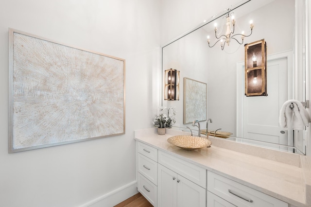 11 Dandelion Dr, Santa Rosa Beach, FL 32459 - bathroom with a chandelier, vanity, and wood finished floors