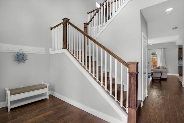 staircase featuring recessed lighting, baseboards, visible vents, and wood-type flooring