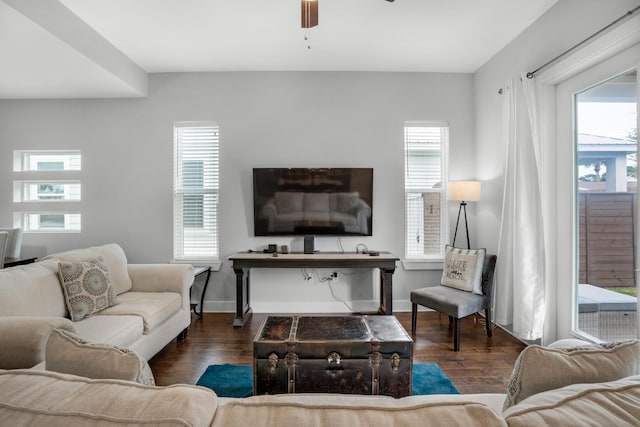 living area with a healthy amount of sunlight, baseboards, ceiling fan, and wood finished floors