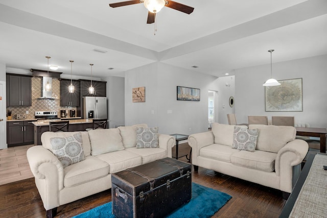 living room featuring a ceiling fan and wood finished floors