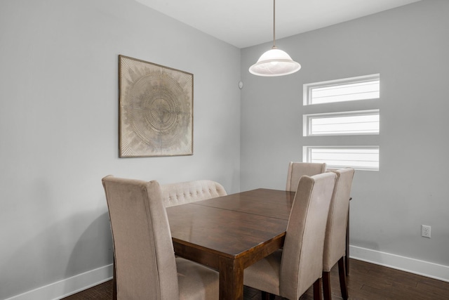 dining room featuring dark wood-type flooring and baseboards