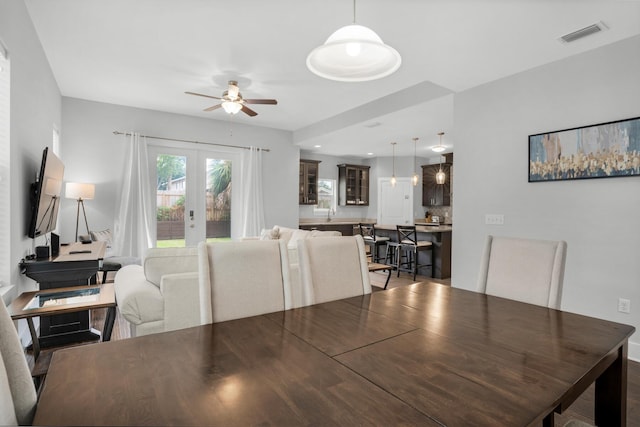 dining space featuring visible vents, ceiling fan, and french doors