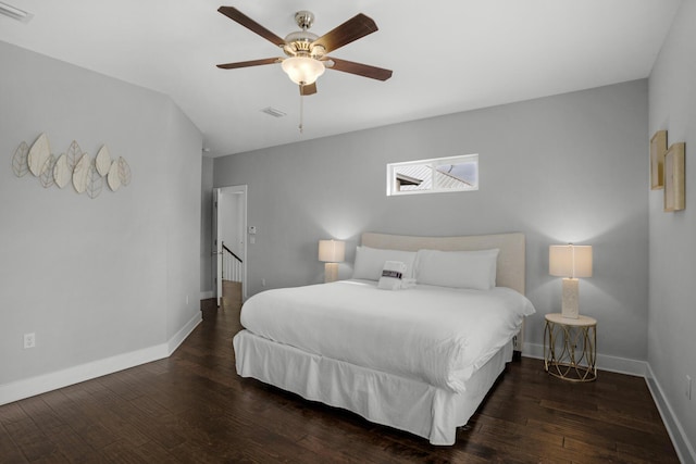 bedroom with visible vents, a ceiling fan, baseboards, and hardwood / wood-style floors