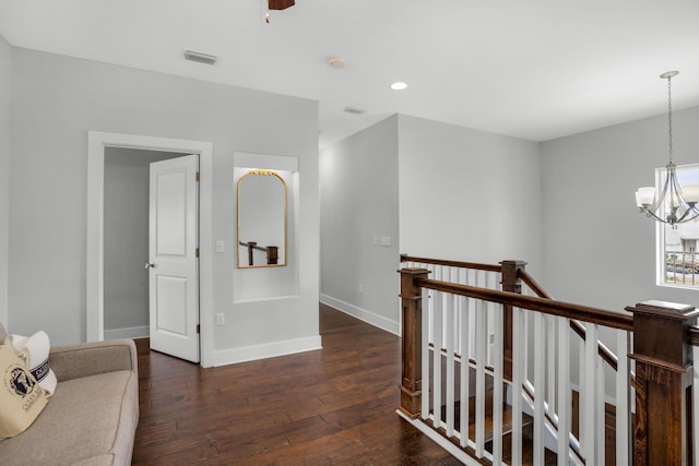 corridor with visible vents, an upstairs landing, dark wood-type flooring, recessed lighting, and baseboards