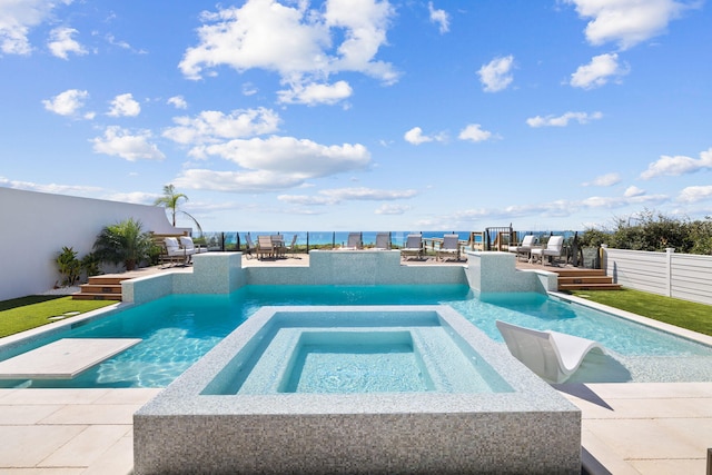 view of pool featuring a deck, outdoor dining space, a pool with connected hot tub, fence, and a patio area