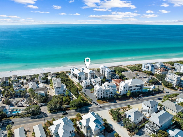 drone / aerial view with a residential view, a water view, and a view of the beach