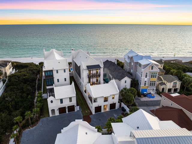 bird's eye view featuring a residential view, a beach view, and a water view