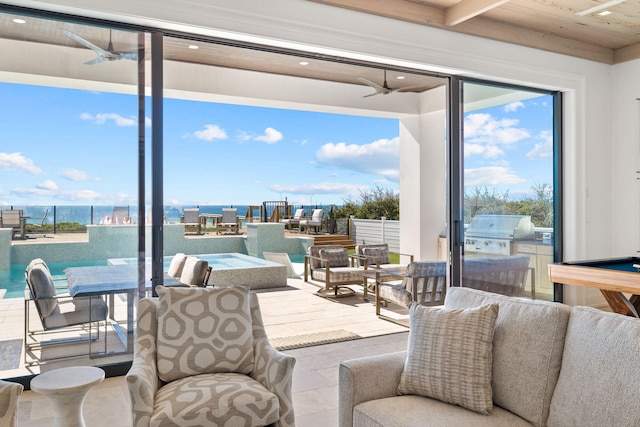 interior space with a grill, ceiling fan, and outdoor dining space