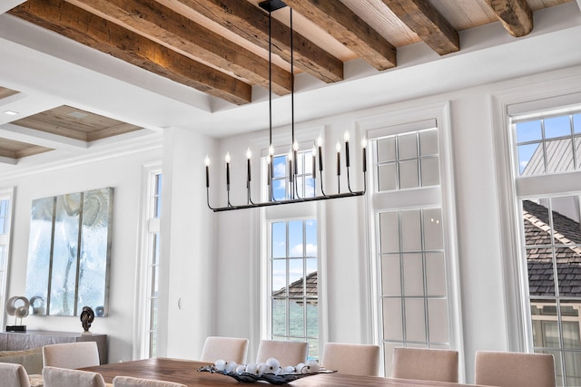 dining space with beam ceiling and a chandelier