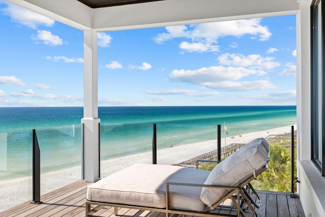 balcony with a water view and a beach view