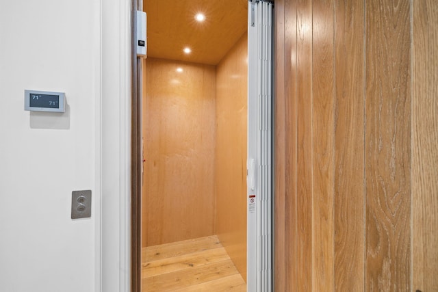 interior details featuring elevator and recessed lighting