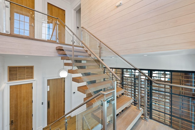 stairs featuring wood finished floors and visible vents