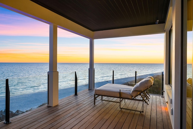 dock area with a beach view and a water view