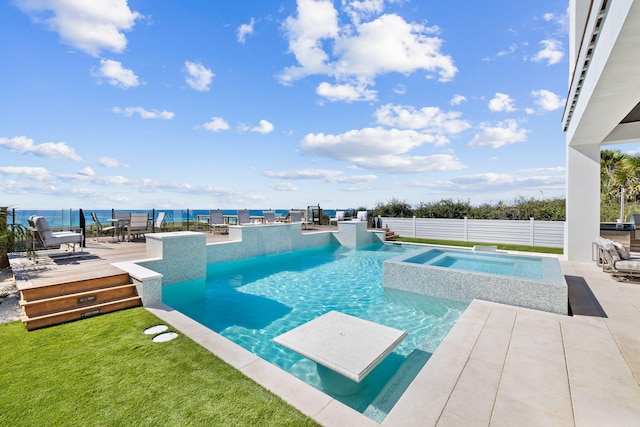 view of pool with a lawn, fence, a wooden deck, a fenced in pool, and an in ground hot tub