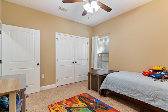 bedroom featuring visible vents, baseboards, carpet, a closet, and a ceiling fan