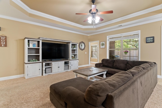 living area with a tray ceiling, baseboards, and carpet floors