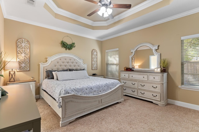 bedroom featuring visible vents, baseboards, light colored carpet, ornamental molding, and a raised ceiling