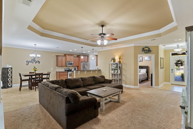 living room featuring a tray ceiling, light tile patterned floors, visible vents, and light carpet