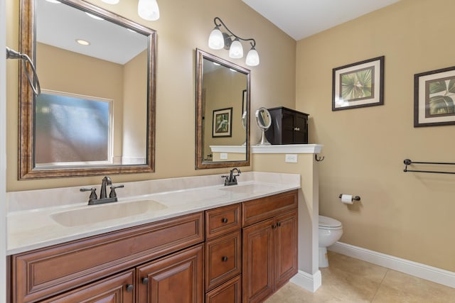 full bath featuring a sink, toilet, double vanity, and tile patterned floors