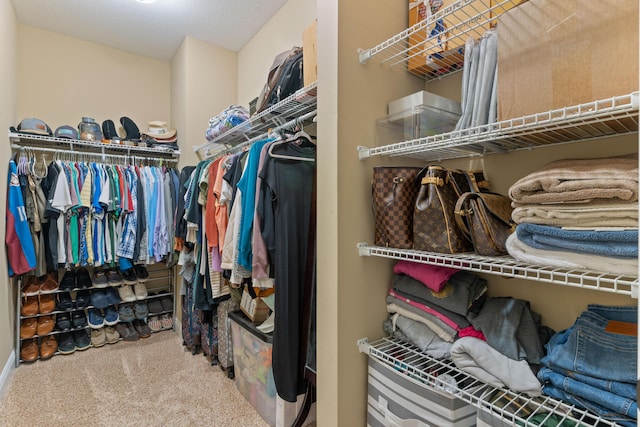 spacious closet with carpet flooring