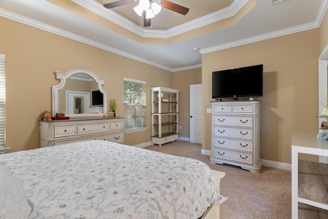 bedroom with baseboards, a raised ceiling, light colored carpet, and crown molding