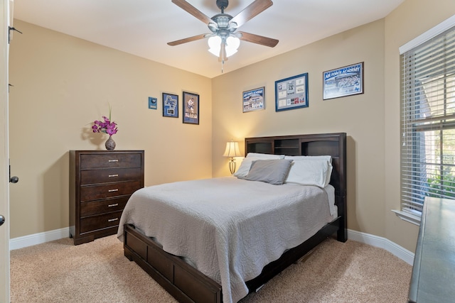 bedroom with baseboards, light carpet, and ceiling fan