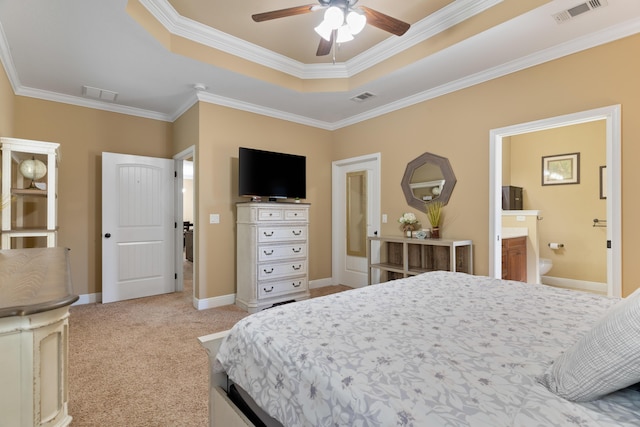 carpeted bedroom with a tray ceiling, visible vents, and baseboards