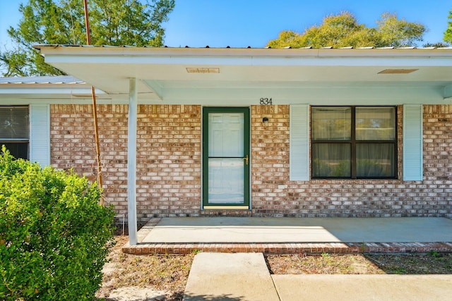 property entrance with brick siding