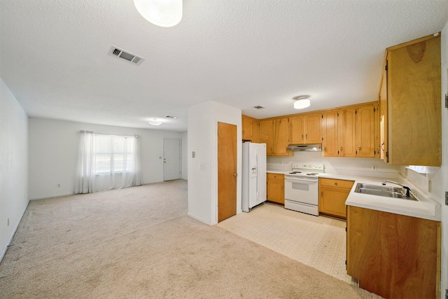 kitchen featuring visible vents, under cabinet range hood, open floor plan, light carpet, and white appliances