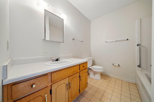 bathroom featuring baseboards, toilet, vanity, and a textured ceiling