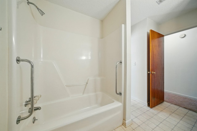 bathroom featuring tub / shower combination, baseboards, and a textured ceiling