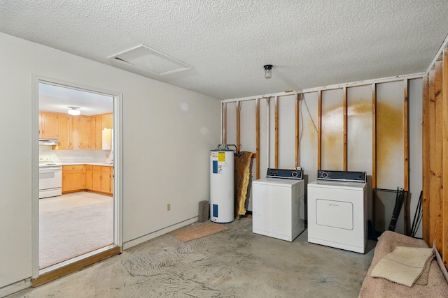 below grade area with a textured ceiling, electric water heater, and washer and clothes dryer