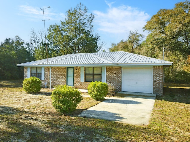 ranch-style house with an attached garage, brick siding, and metal roof