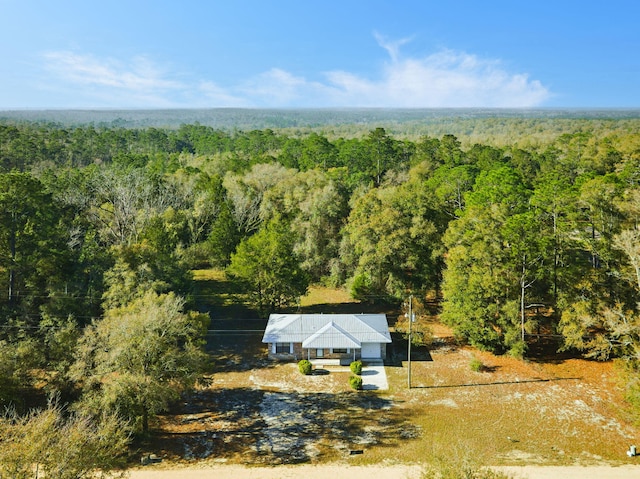 birds eye view of property featuring a view of trees