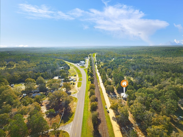 drone / aerial view with a wooded view